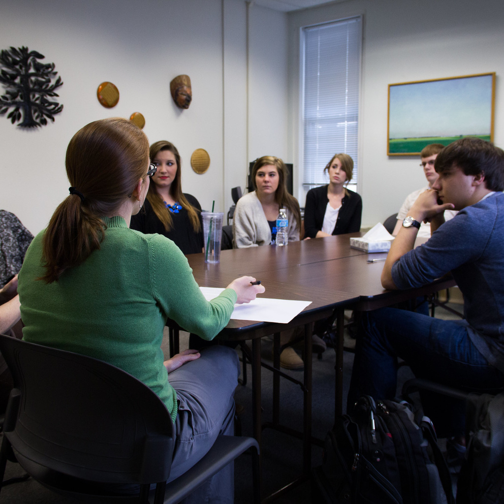 students and counselors sitting around conference table