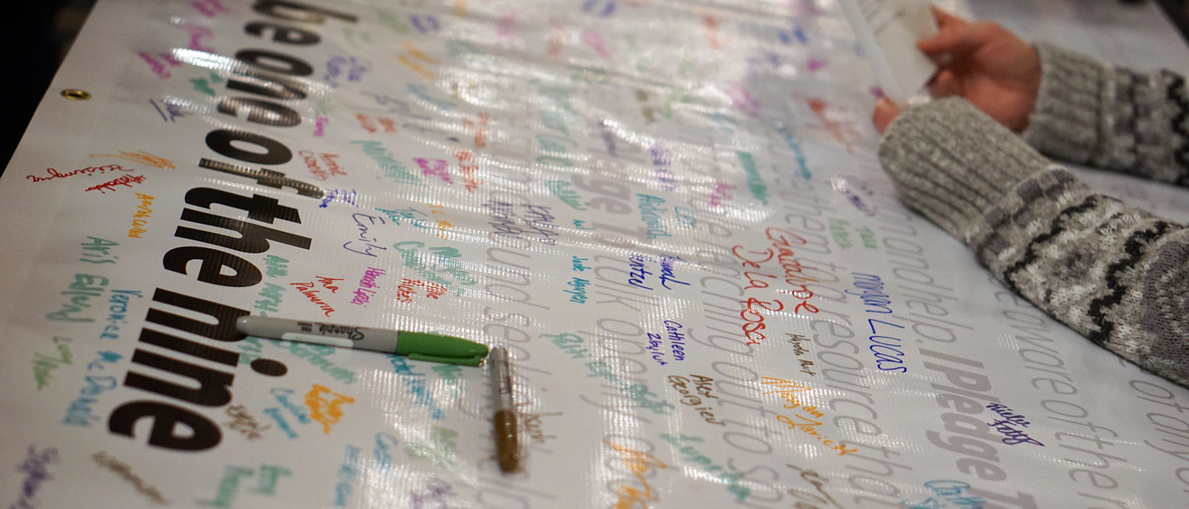 banner with markers for people to sign their name