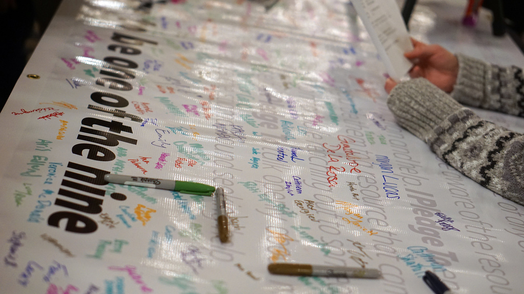 banner with markers for people to sign their name